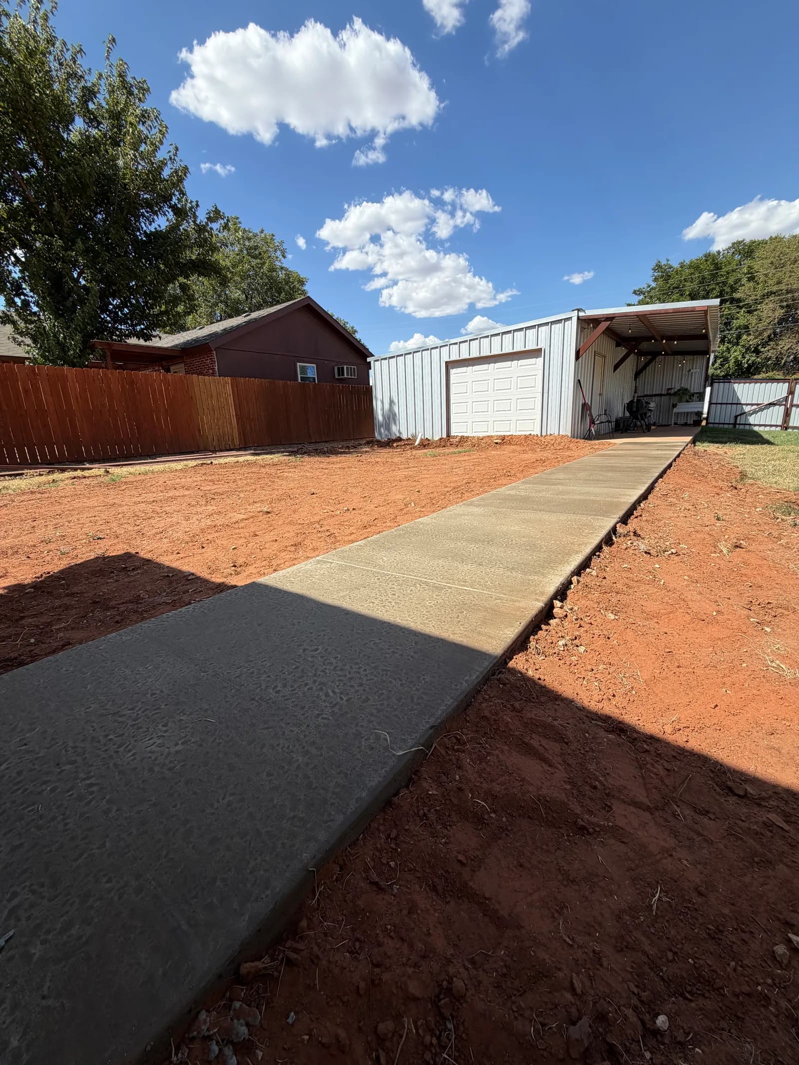 Childress Backyard Concrete Sidewalk — finished jointed walkway across the yard in Childress, TX